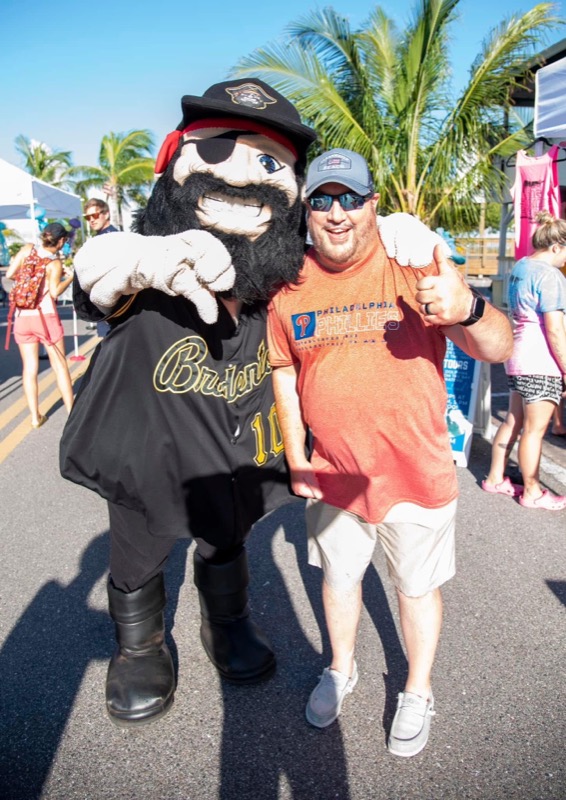 Marty the Marauder mascot posing with a fan