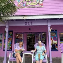 Friends relaxing outside a pink shop on Bridge Street